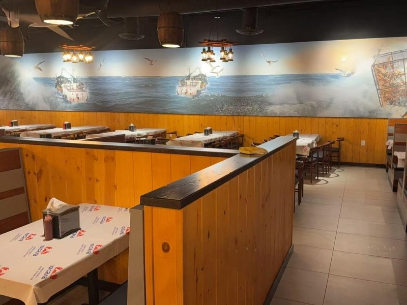 Coastal-themed dining area with ocean mural at 101 Crab, a Seafood Restaurant in Santa Maria