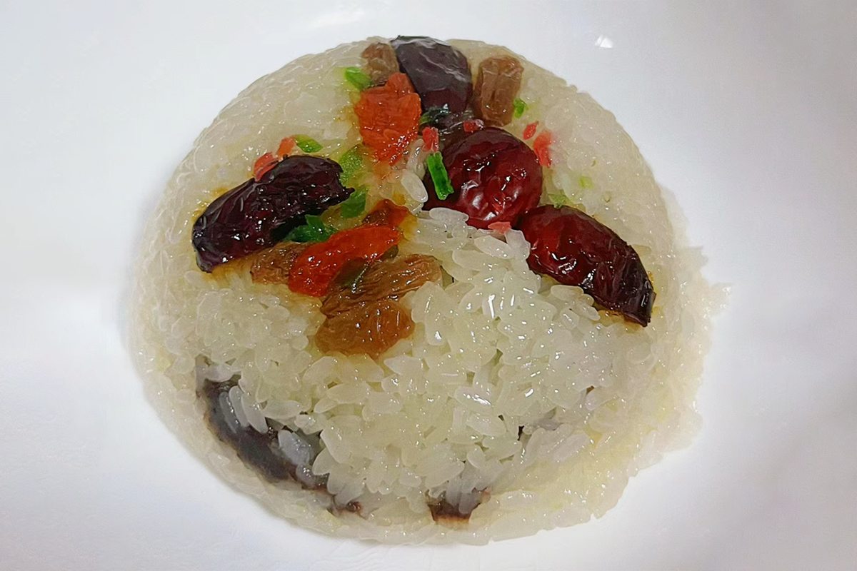 Sticky rice steamed with a colorful mix of nuts, dried fruits, and sweet bean paste, creating a fragrant and comforting traditional dessert at Dim Sum Taste，a Chinese Restaurant in West Chester