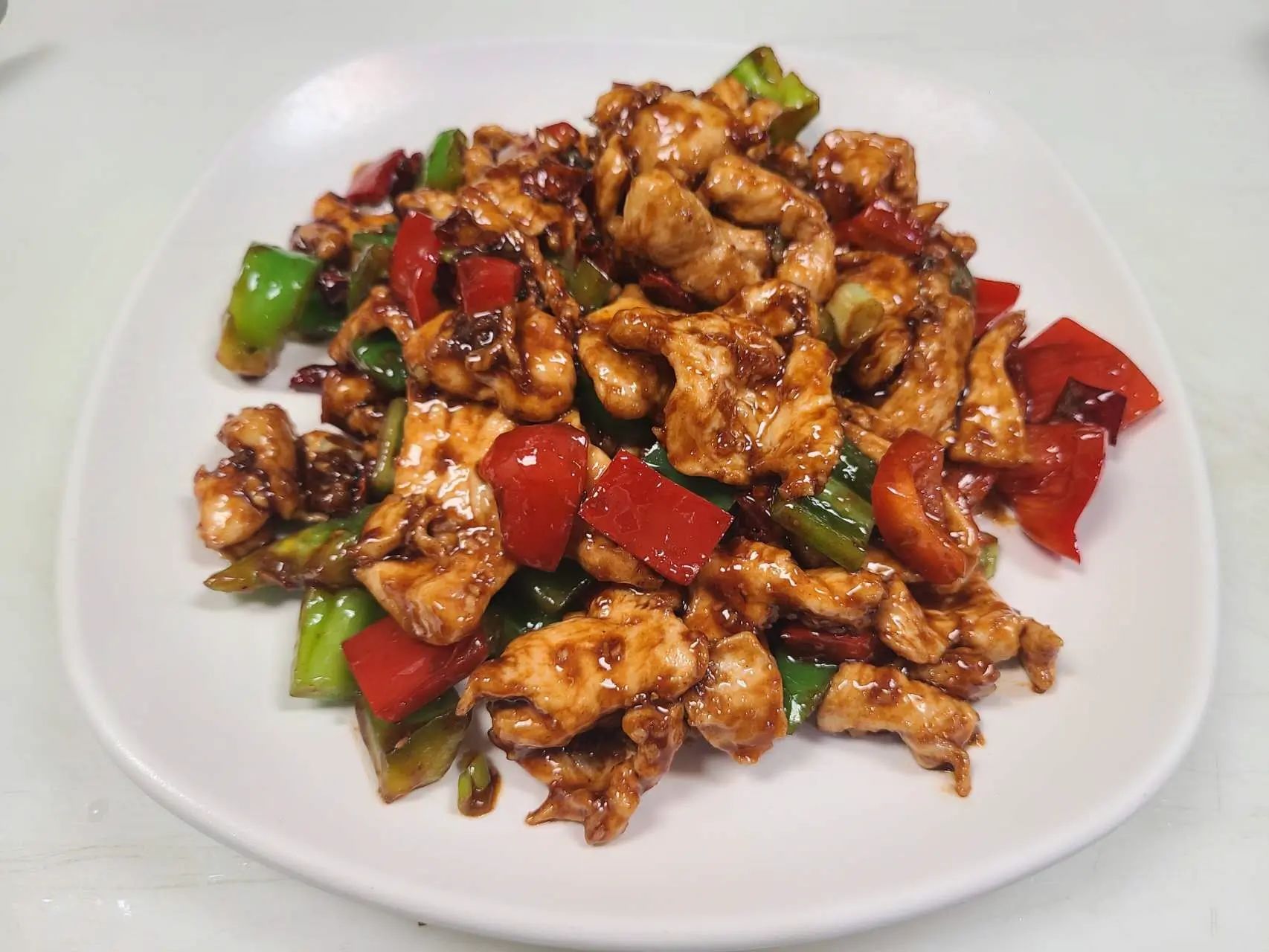 Stir‑fried chicken slices with green and red peppers at 1st Dumpling N Noodle, a Chinese Restaurant in CA