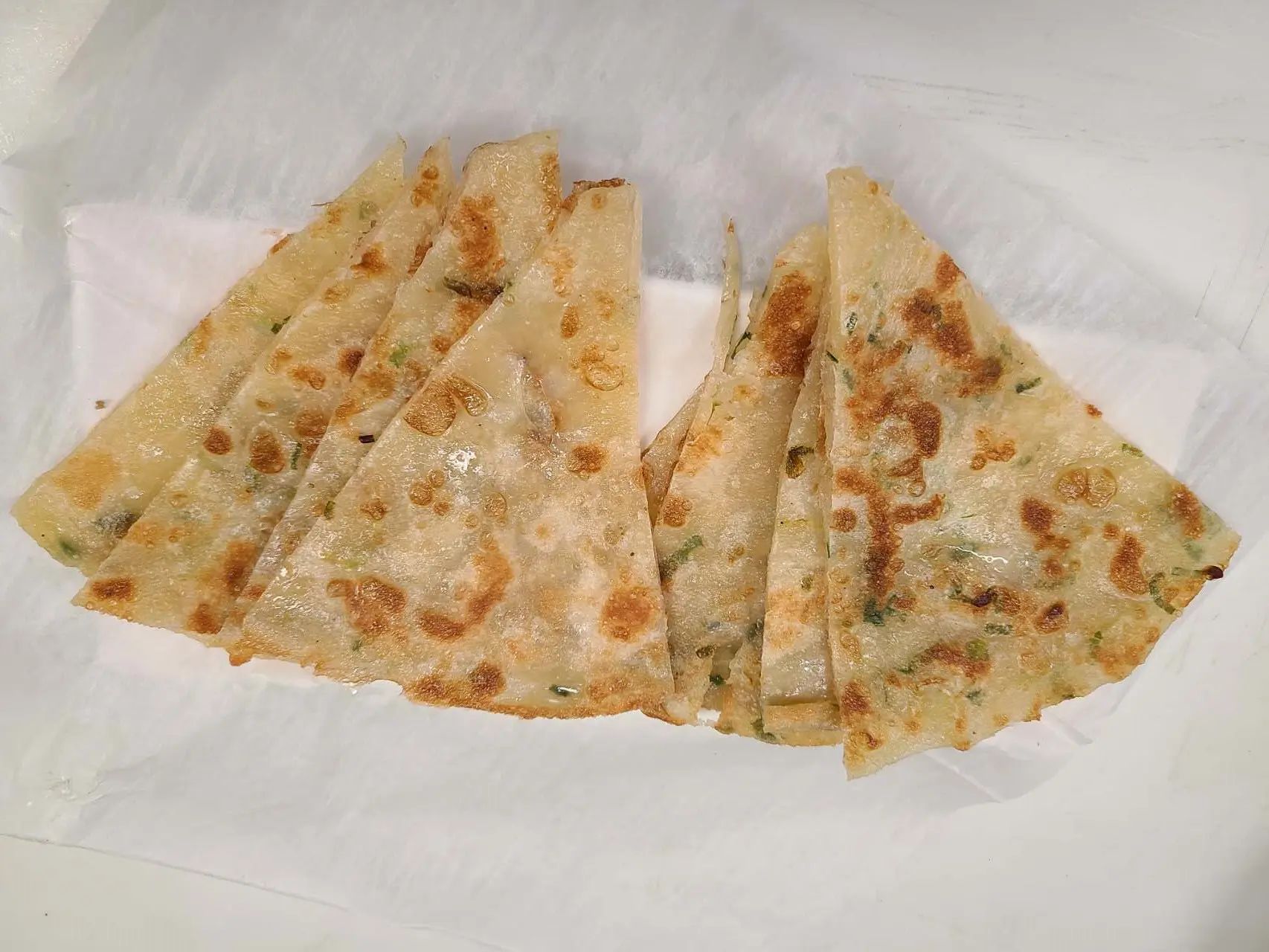 Crispy scallion pancake cut into triangles at 1st Dumpling N Noodle, a Chinese Restaurant in CA