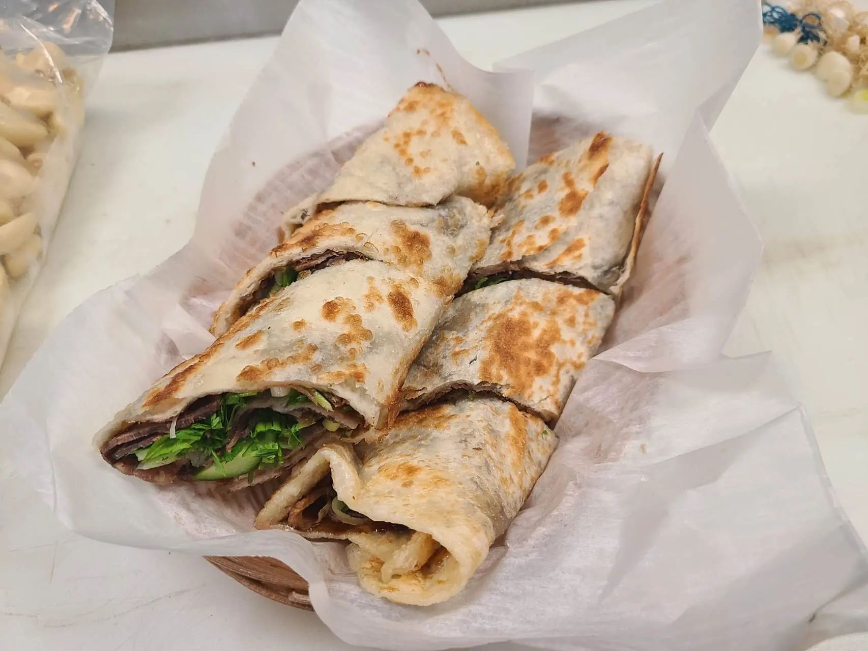 Beef wrapped in crispy flatbread with fresh vegetables at 1st Dumpling N Noodle, a Chinese Restaurant in CA