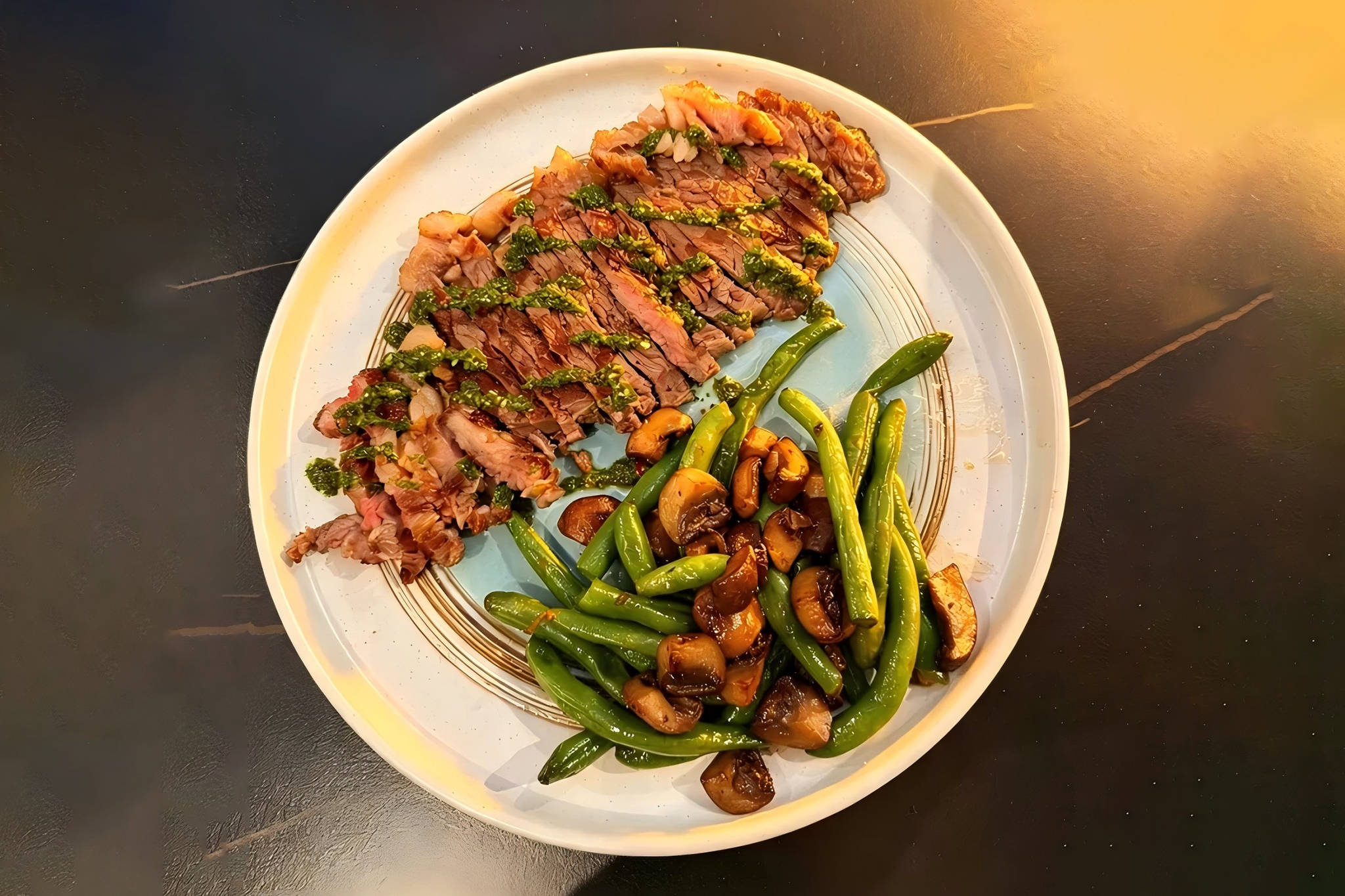 Sliced steak with green beans, mushrooms and herb sauce