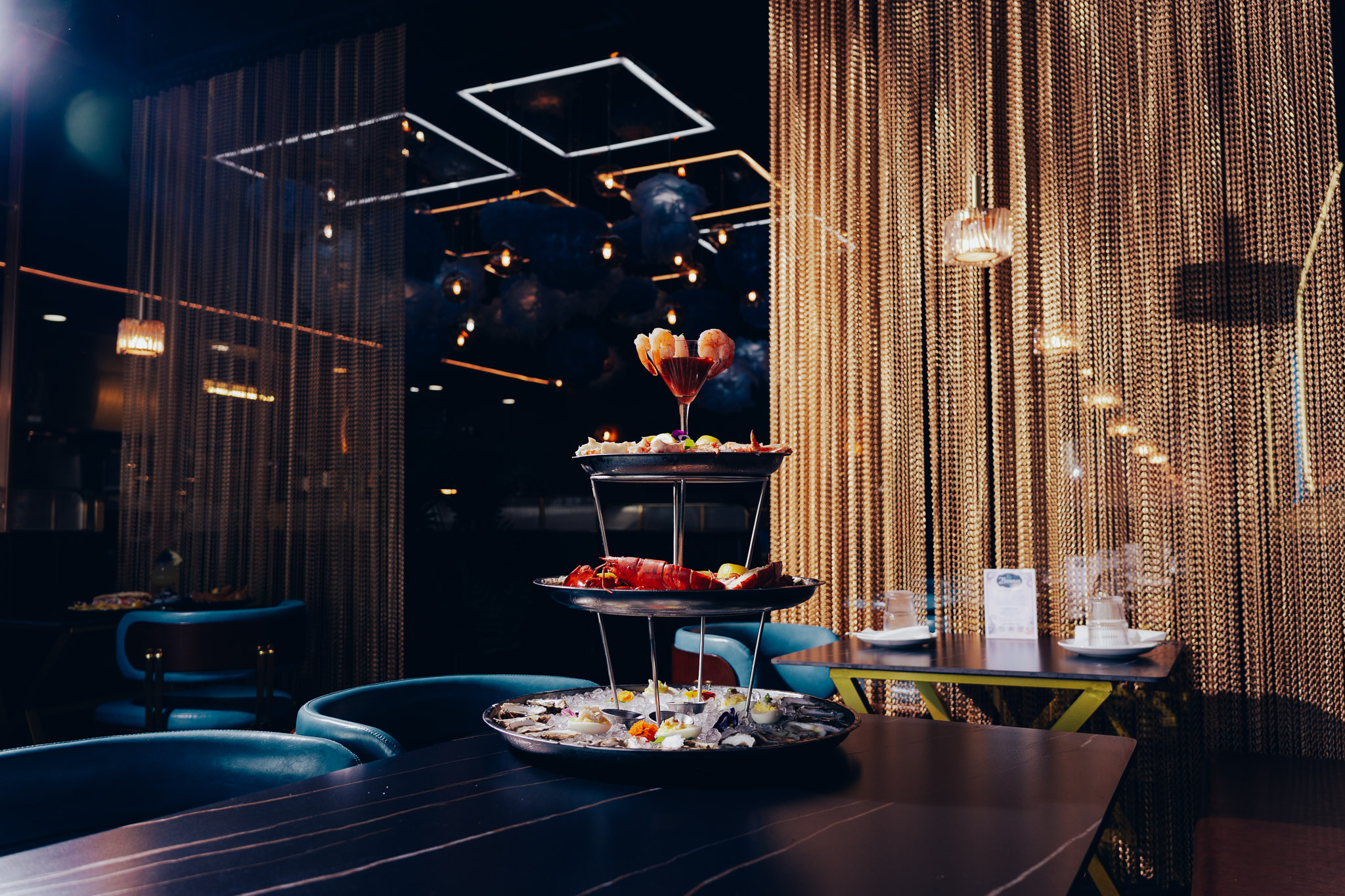 Three-tier chilled seafood tower inside stylish restaurant