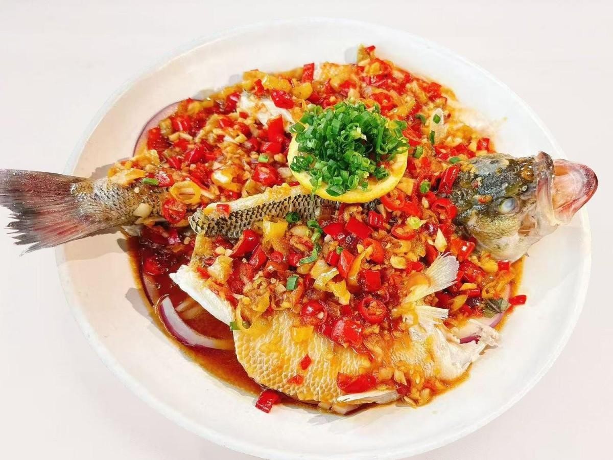 Poached sea bass topped with spicy condiments at 28° North Old Changsha, a Chinese Restaurant in Rowland Heights.