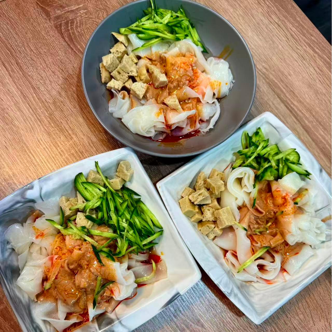 Cold rice noodles topped with tofu cubes and cucumber shreds at 3 He Noodles, a Chinese Restaurant in Temple City
