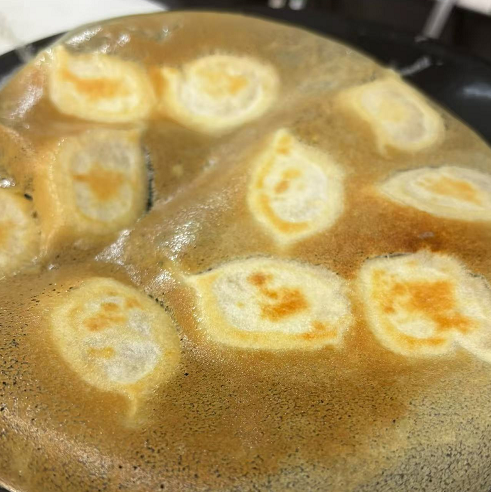 Crispy skin pan - fried dumplings with golden - brown crust at 3 He Noodles, a Chinese Restaurant in Temple City