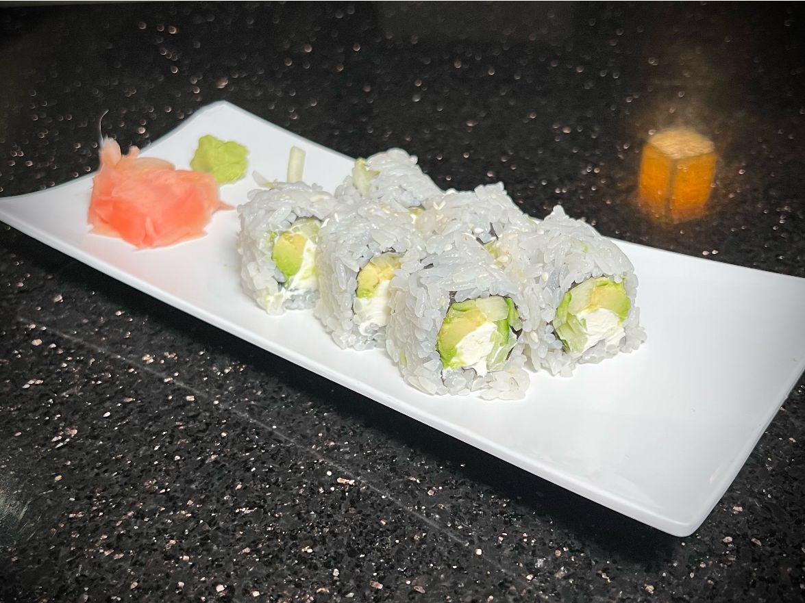 Sushi ACC roll with fresh avocado and crunchy fillings on white plate at 592 Korean BBQ, an Asian Fusion Restaurant in Appleton