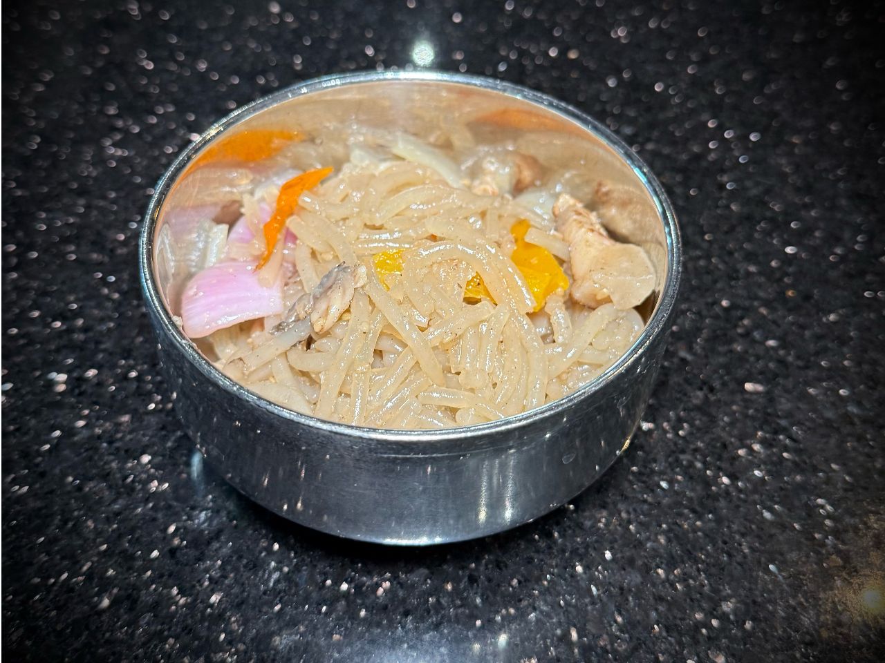 Japchae stir‑fried glass noodles with mixed vegetables in metal bowl at 592 Korean BBQ, an Asian Fusion Restaurant in Appleton