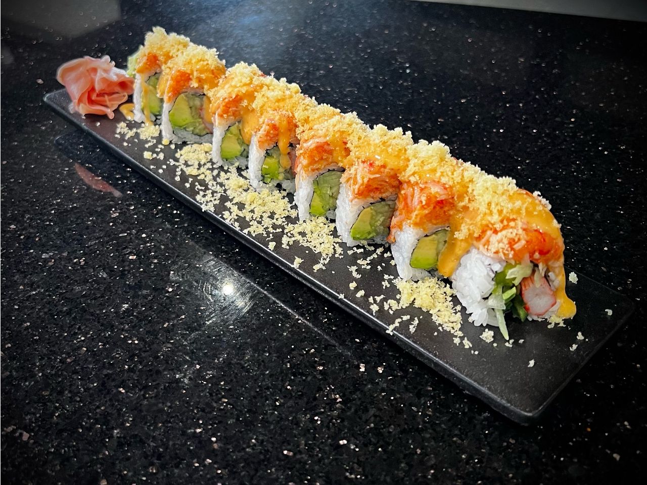 Phoenix sushi roll covered with crispy tempura crumbles and sauce at 592 Korean BBQ, an Asian Fusion Restaurant in Appleton