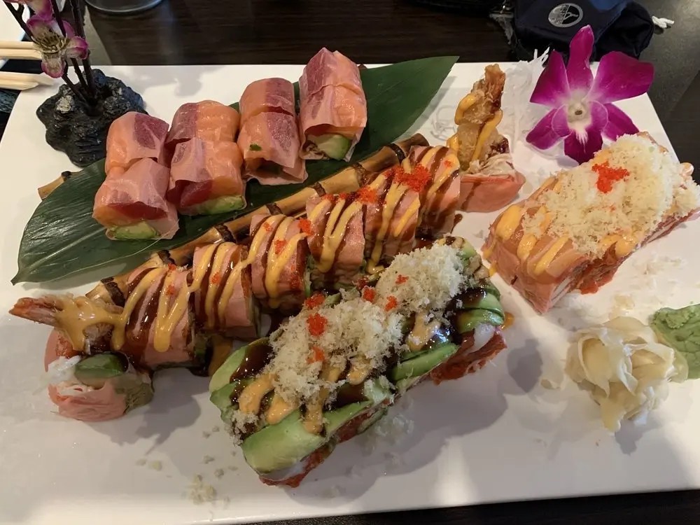 Salmon-wrapped sushi rolls with toppings at E Sushi & Grill, a Japanese Restaurant in Apollo Beach