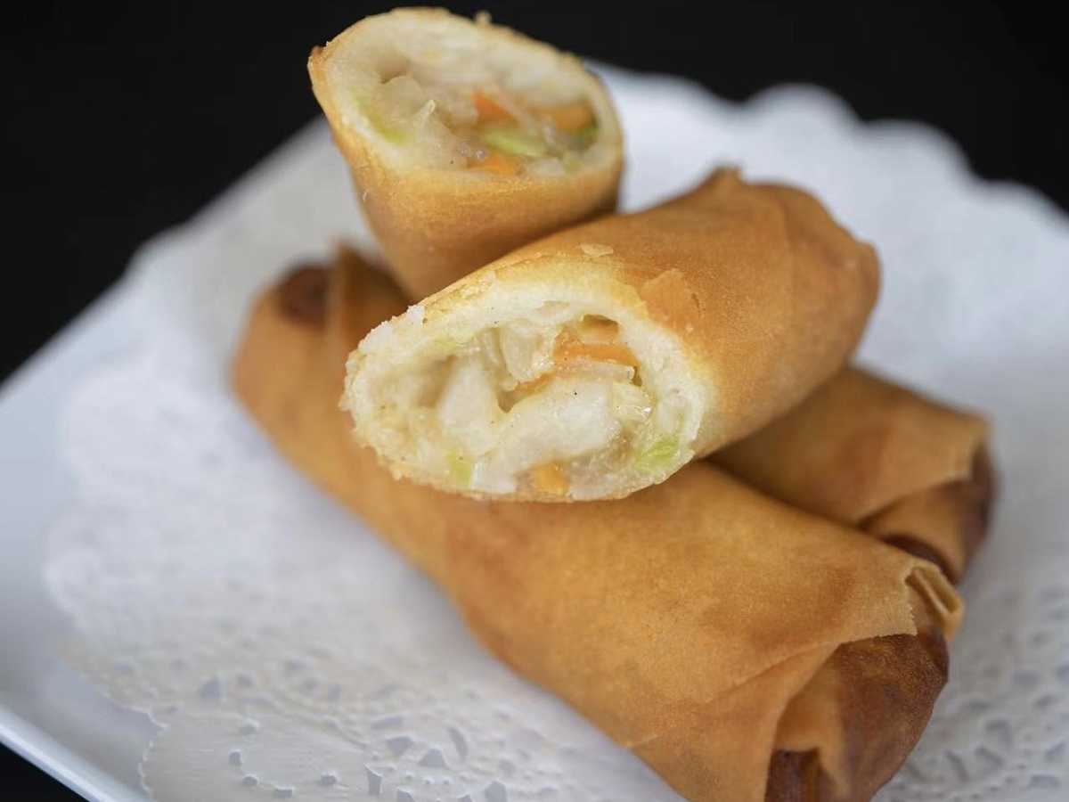 Vegetarian Spring Rolls placed on a plate, filled with vegetables and wrapped in thin pastry at Seven Folding Dumpling House，a Chinese Restaurant in Mission Viejo