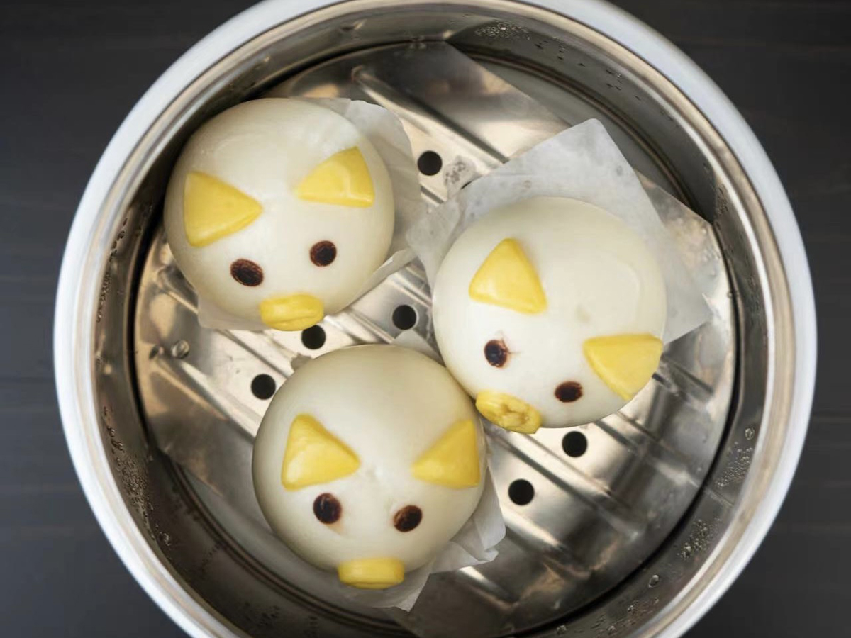 Red Bean Buns with cute cartoon - like designs on top, filled with sweet red bean paste at Seven Folding Dumpling House，a Chinese Restaurant in Mission Viejo