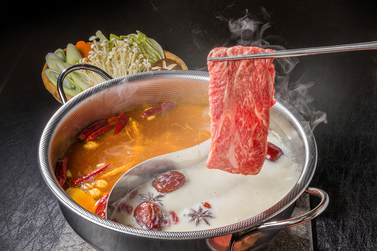88-Korean-BBQ-and-Hot-Pot-Asian-Fusion-Restaurant-Fresh-cut-Beef-Hot-Pot-Frisco slices of fresh beef being cooked in a simmering pot at 88 Korean BBQ and Hot Pot,a Asian Fusion Restaurant in Frisco
