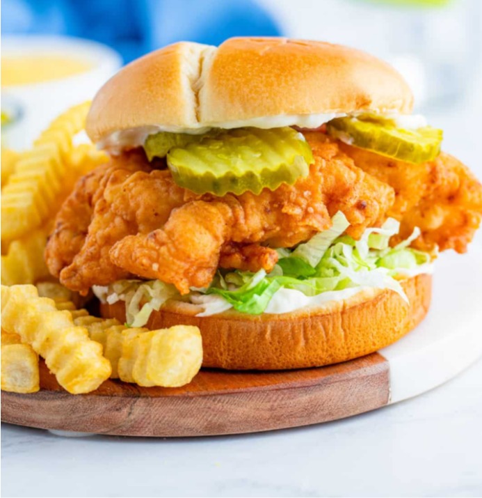 Crispy chicken sandwich with pickles and crinkle-cut fries