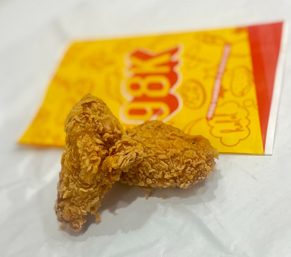 Crispy fried chicken pieces with branded packaging