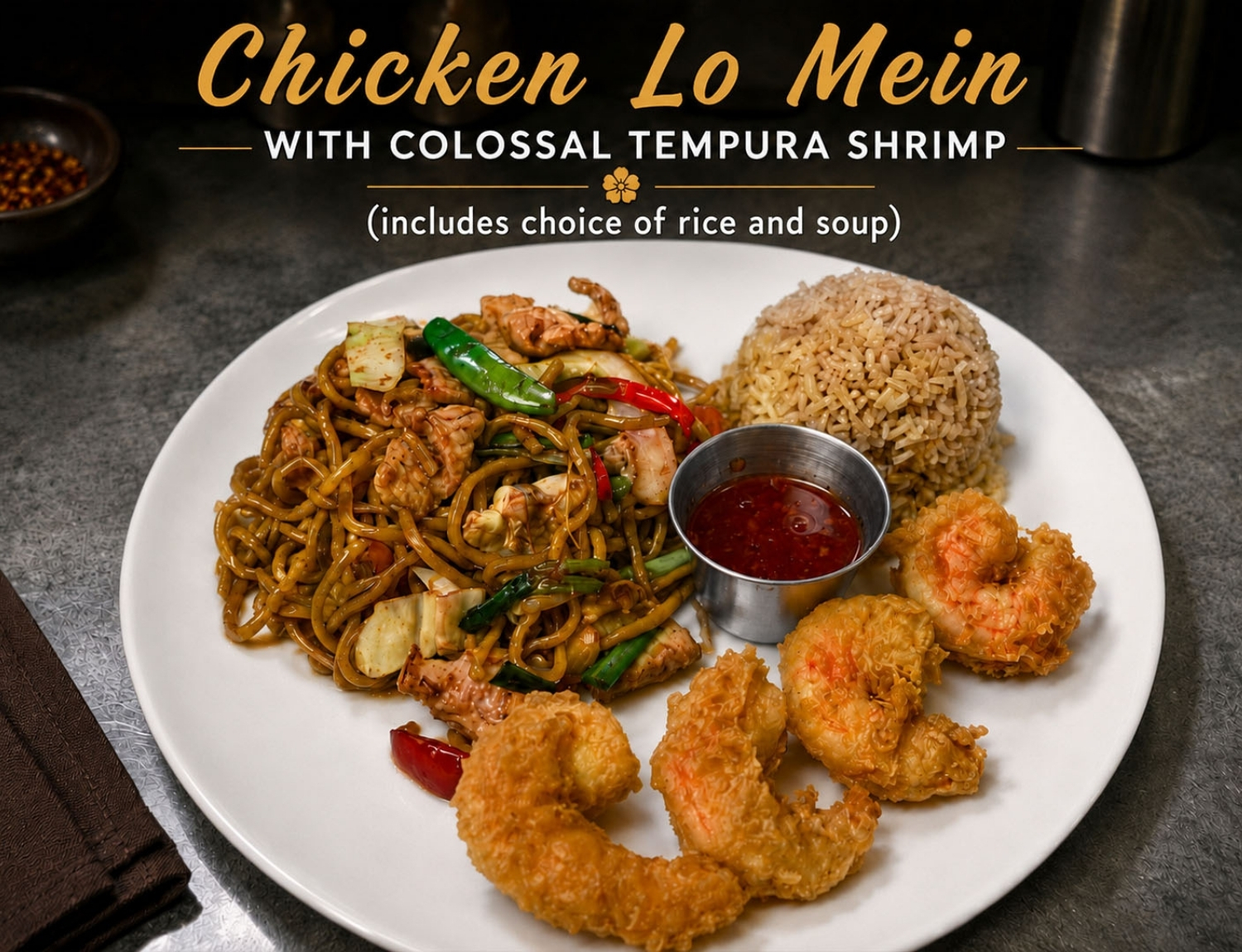 Chicken lo mein served with large tempura shrimp, rice and sauce.