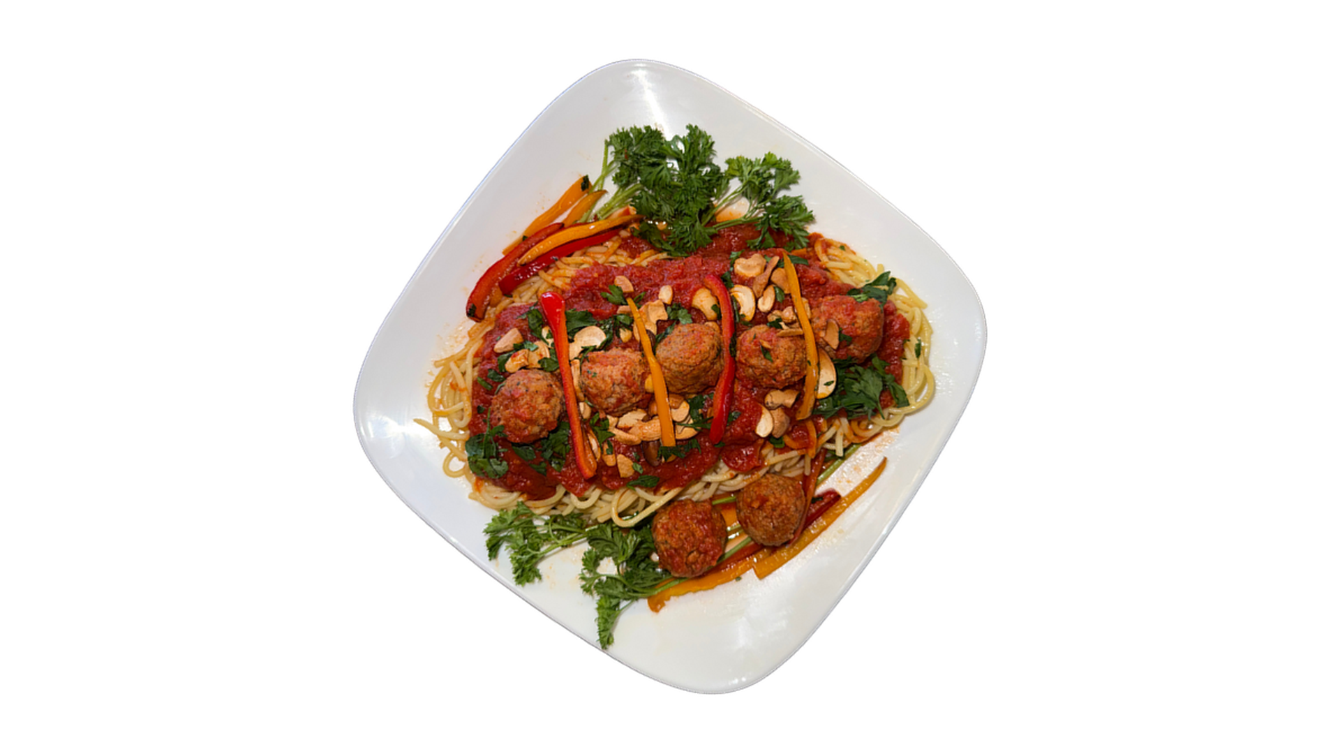 Pasha Meatballs served over spaghetti with tomato sauce herbs and vegetables