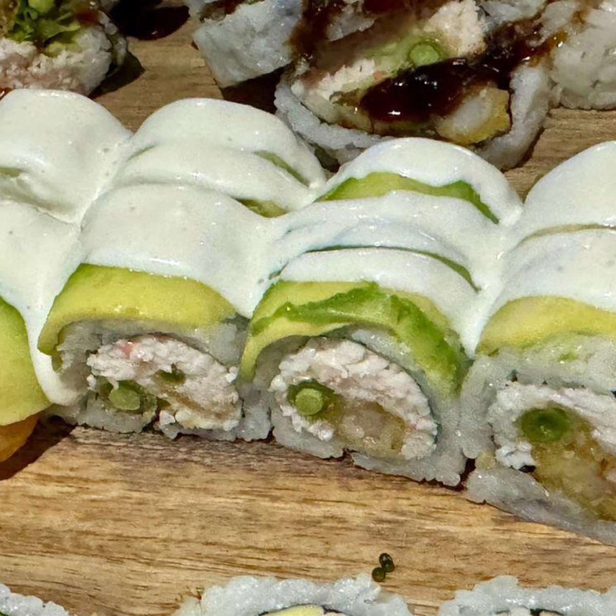 Avocado sushi roll with creamy sauce at Aji Sushi, an Sushi Restaurant in Sacramento