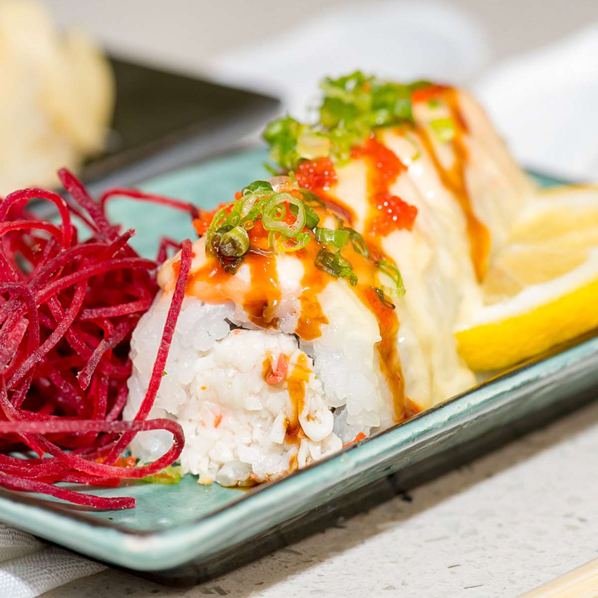 Crab and fish sushi roll with roe and green onion at Aji Sushi, an Sushi Restaurant in Sacramento