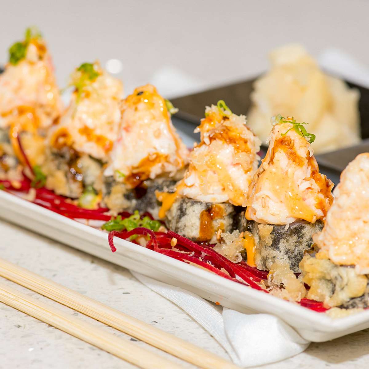 Crab-topped sushi roll with tempura base at Aji Sushi, an Sushi Restaurant in Sacramento
