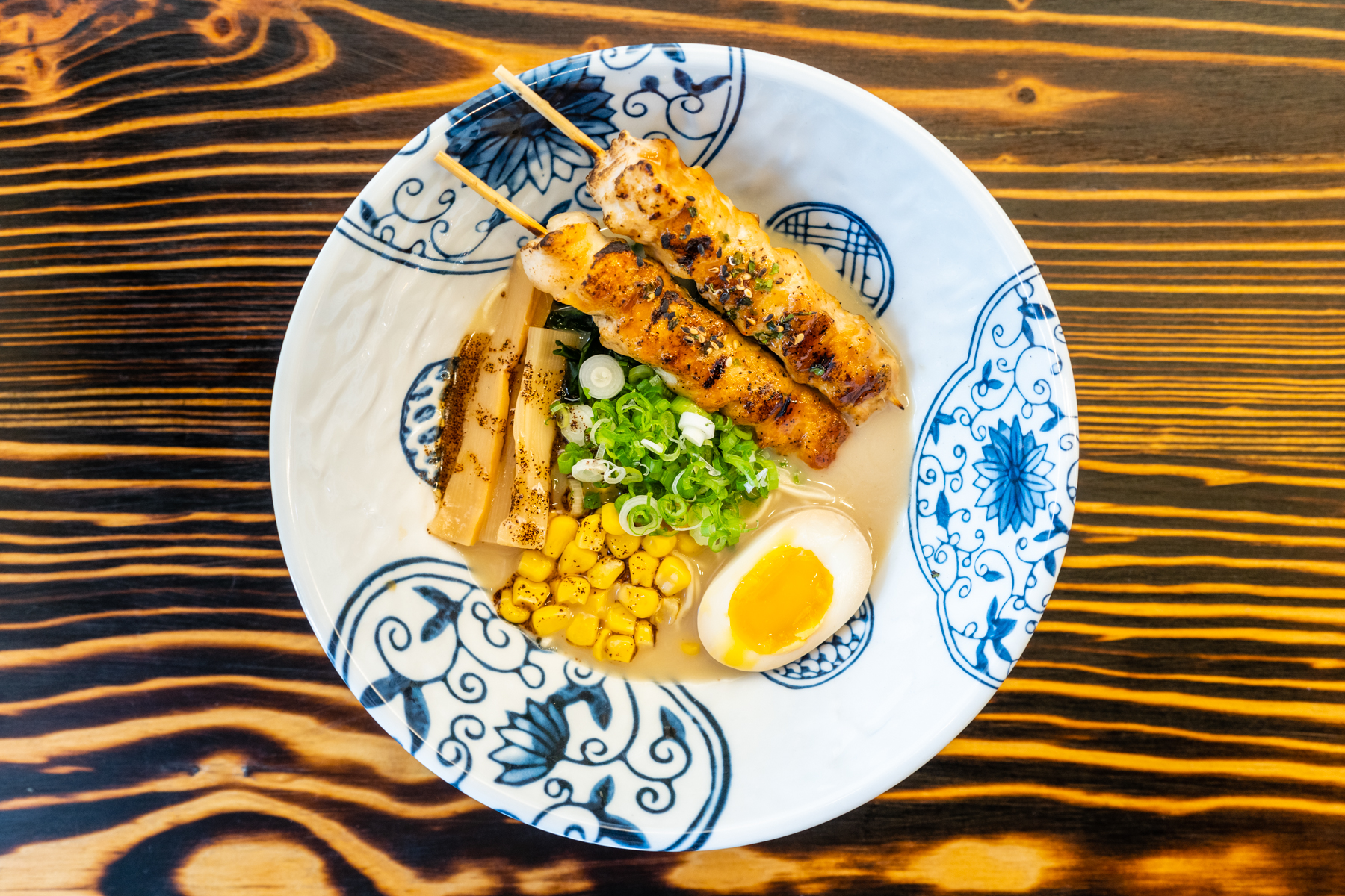 Ramen with chicken skewers, egg and corn at Aji Izakaya Cypress, a Japanese Restaurant in Cypress