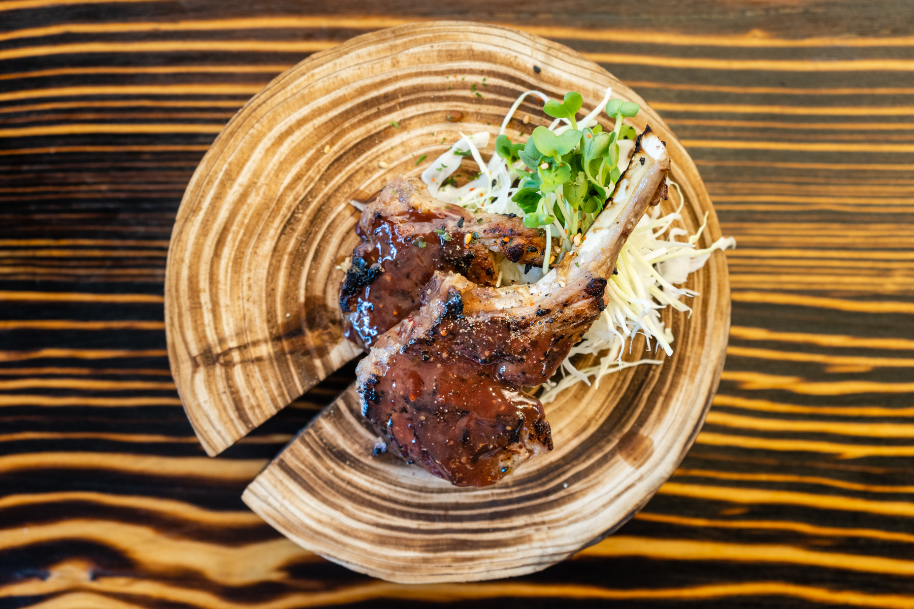 Glazed grilled lamb chops with greens at Aji Izakaya Cypress, a Japanese Restaurant in Cypress