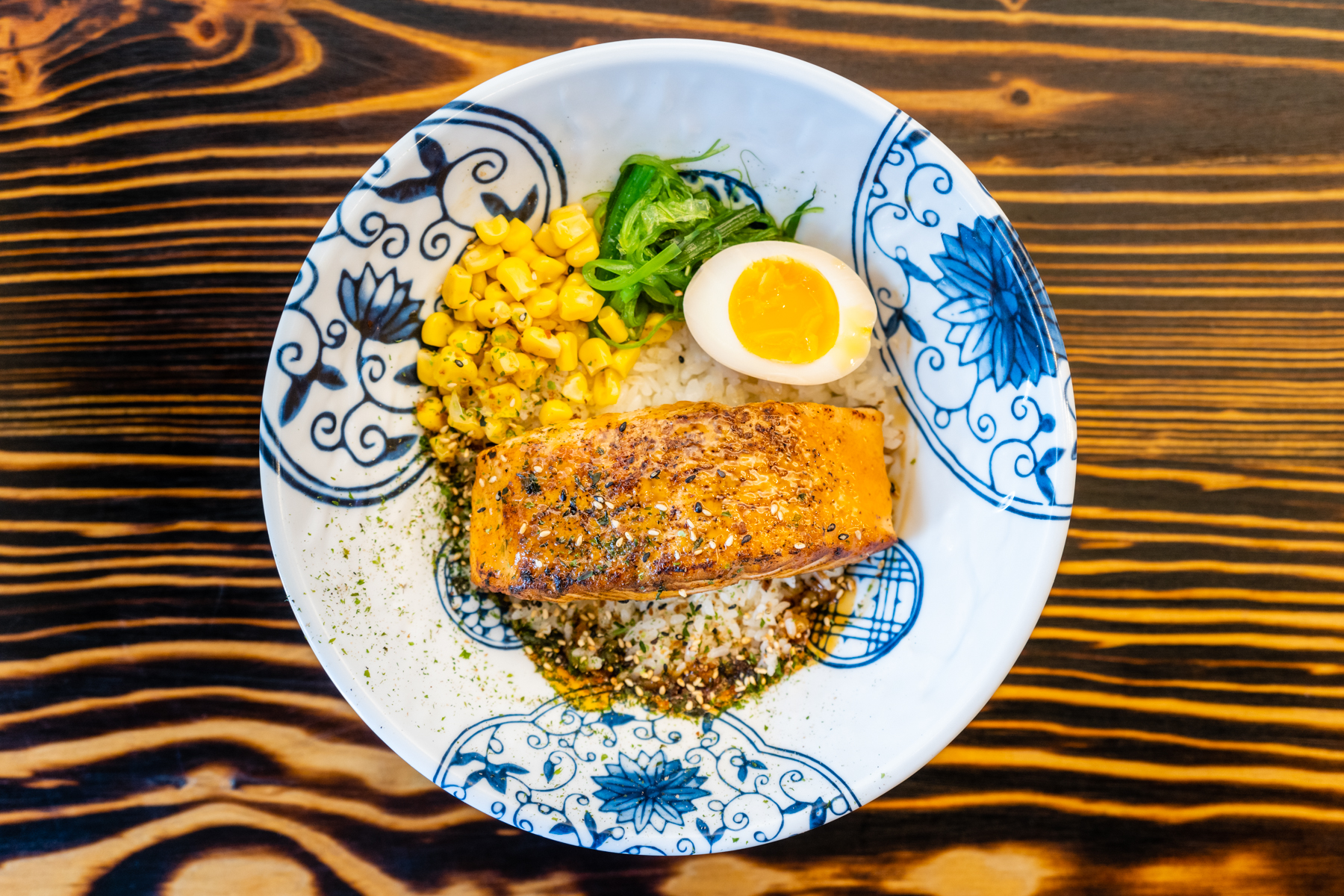 Seared salmon bowl with egg and corn at Aji Izakaya Cypress, a Japanese Restaurant in Cypress