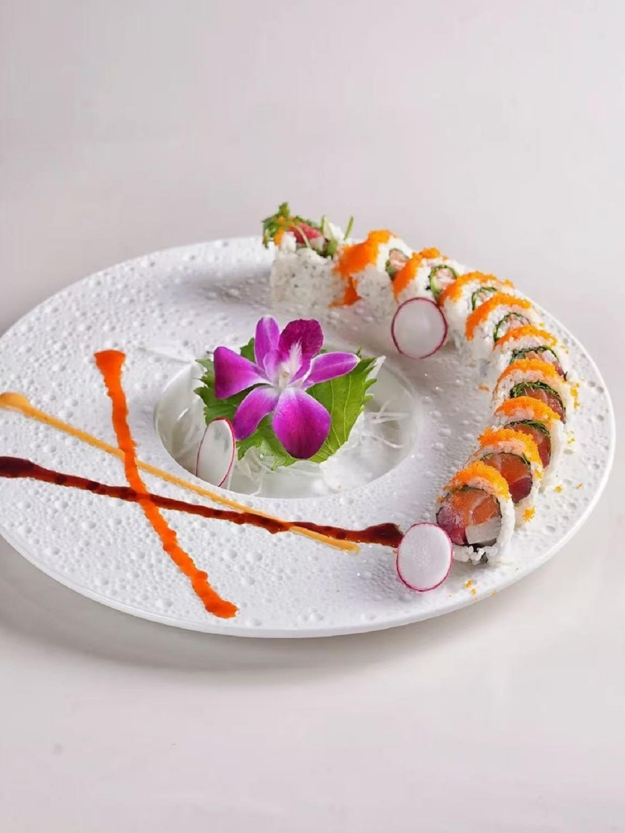 Colorful rainbow roll sushi with fish roe and radish garnish at AJI Koharu Sushi & Grill, a Sushi Restaurant in Federal Way