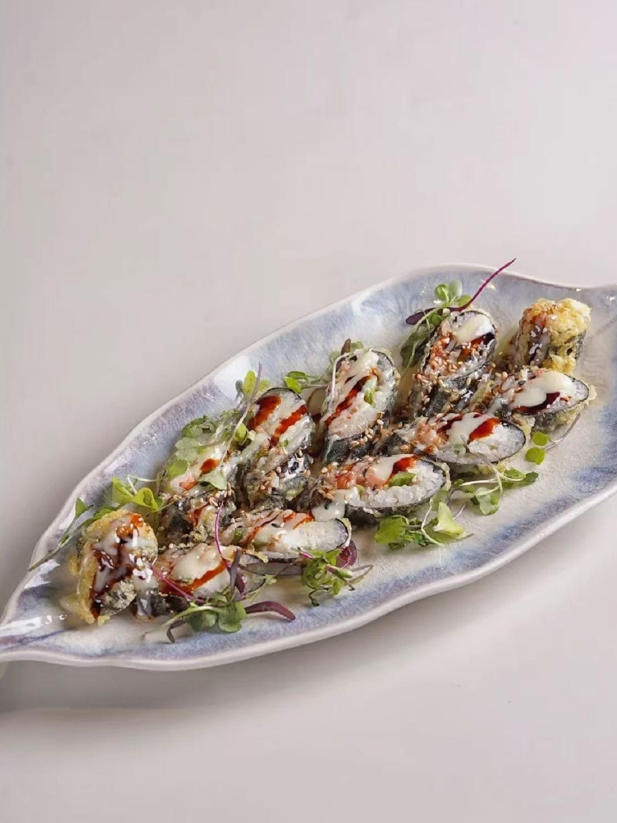 Crispy tempura sushi roll with drizzled sauces and microgreens at AJI Koharu Sushi & Grill, a Sushi Restaurant in Federal Way