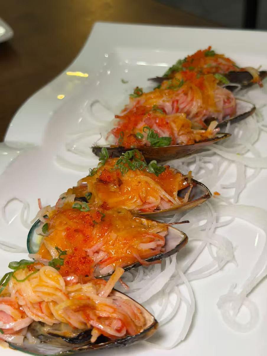 Mussels stuffed with cheese, veggies and topped with sauce at Akagi, a Japanese restaurant in Rockville