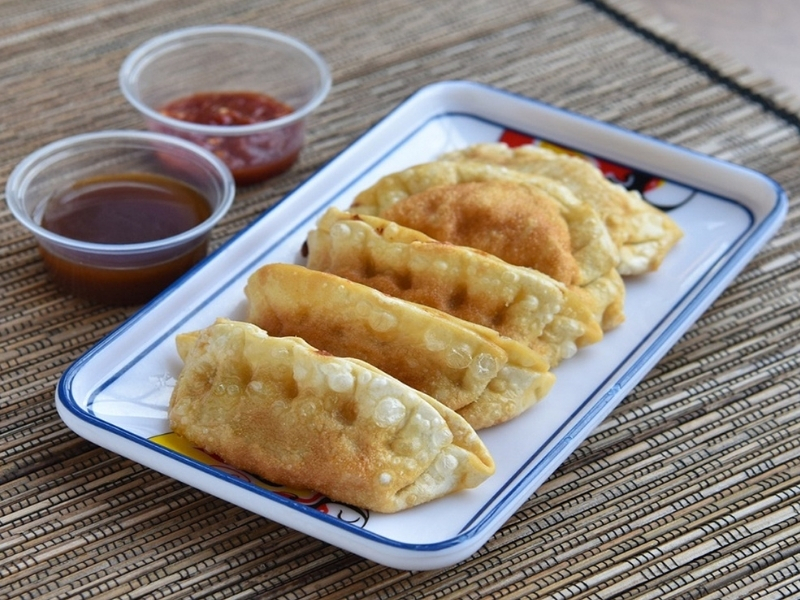 Crispy fried dumplings with dipping sauces at Akahana Asian Bistro Bar & Sushi, a Asian Restaurant in Fort Mill