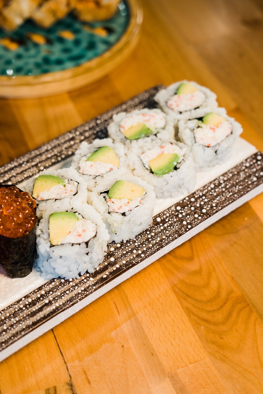 Crab meat maki roll with avocado and tobiko