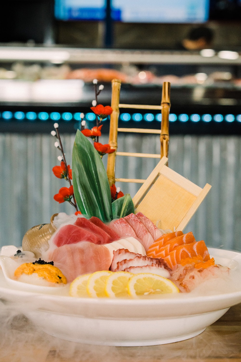 Premium sashimi platter on ice with dry ice mist effect