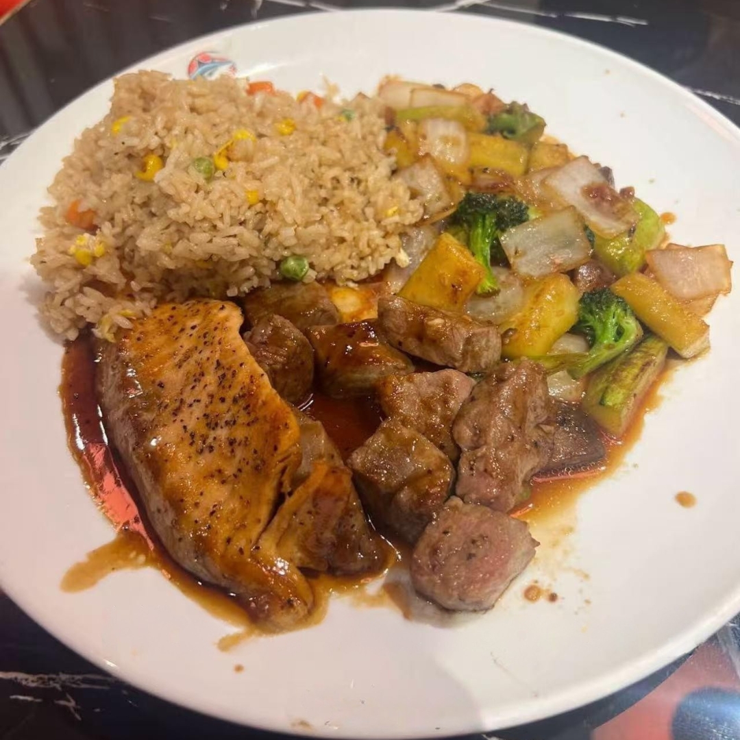 Rice, veggies, steak and salmon on a plate at AKAMI Sushi & Grill,a Japanese Restaurant in Dawsonville