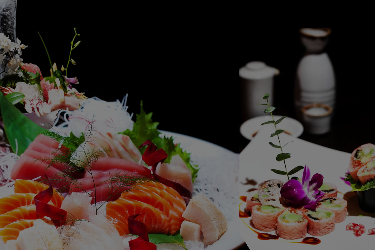 Artfully arranged sashimi and sushi combo platter garnished with fresh greens and decorative purple orchid at Akira, a Japanese Restaurant in Glenmont