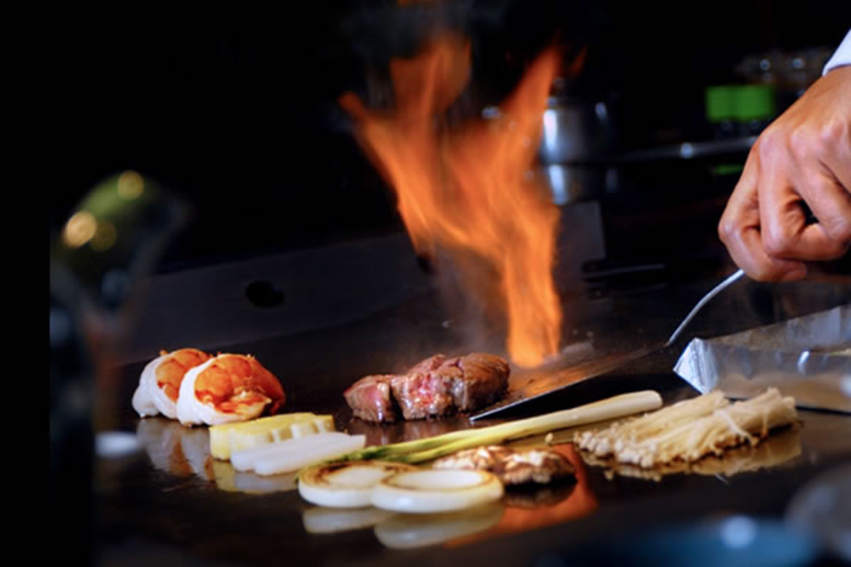 Hibachi grill with flame and vegetables at Akira, a Japanese Restaurant in Glenmont