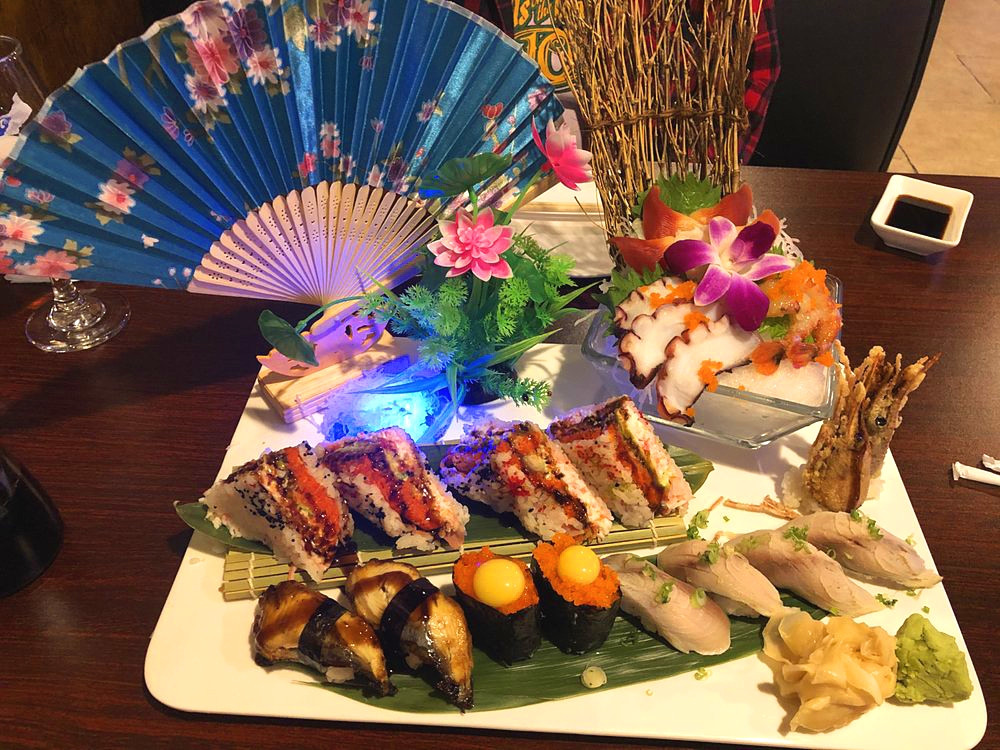 Assorted sushi with fan decor, including nigiri and rolls at Ako Sushi & Seafood, a Japanese Restaurant in Titusville