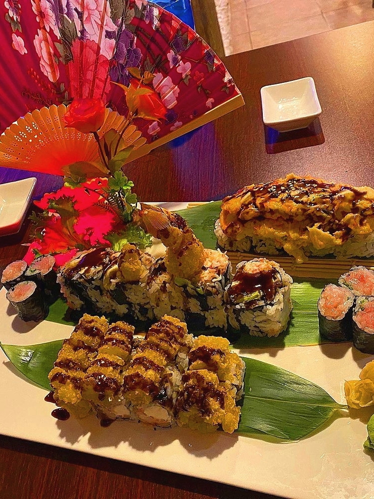 Variety of sushi rolls with eel sauce, served on decorative platter at Ako Sushi & Seafood, a Japanese Restaurant in Titusville