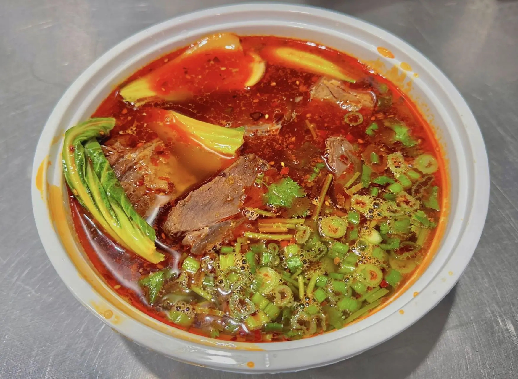Spicy beef noodle soup with vegetables at All In 牡丹，a Chinese Taiwanese Restaurant in Rowland Heights