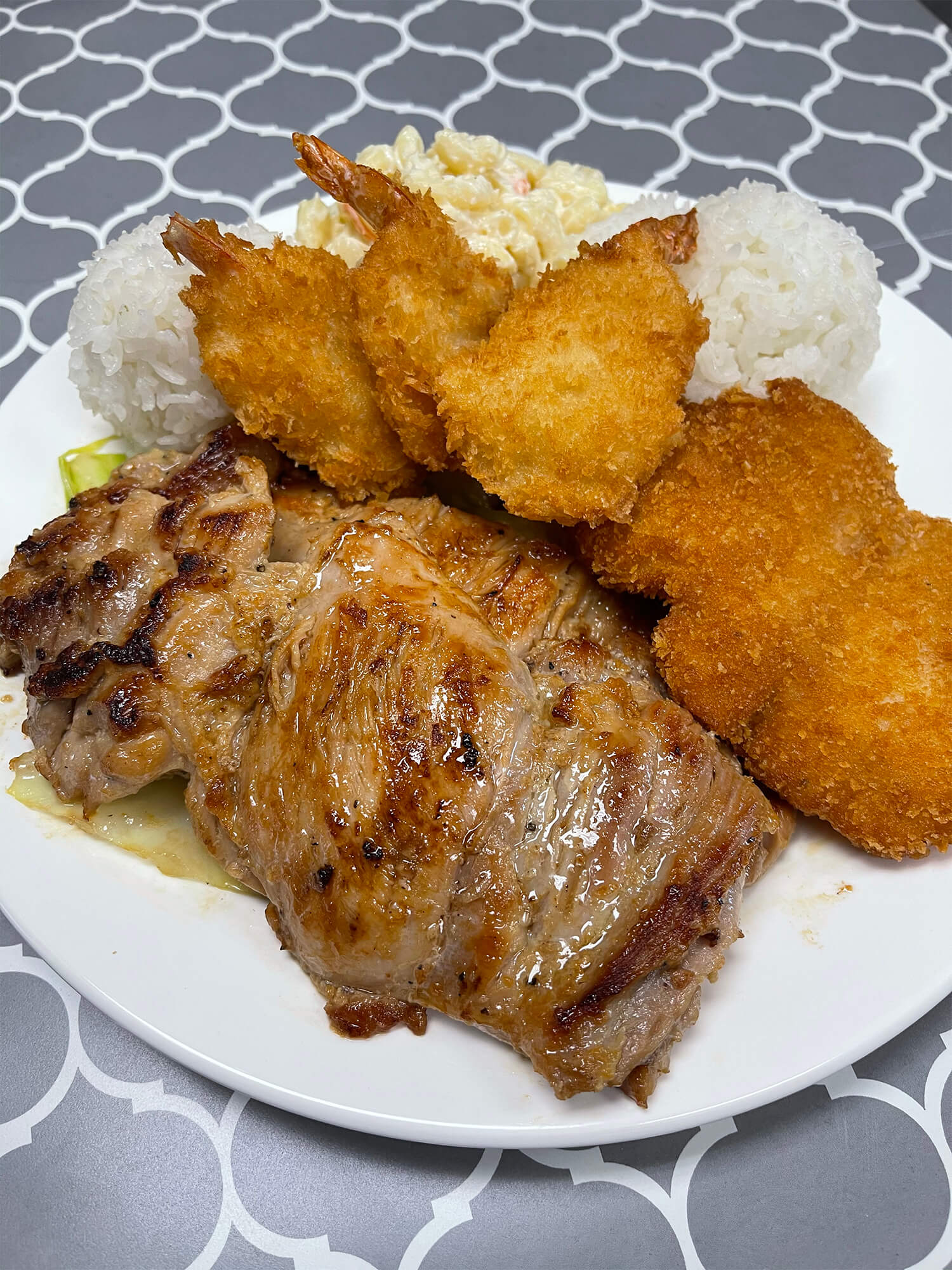 Grilled pork and fried shrimp served with rice and potato salad Sushi burrito with chicken, avocado, and vegetables at Aloha Hawaiian BBQ & Sushi, a Asian Fusion restaurant in Baldwin Park