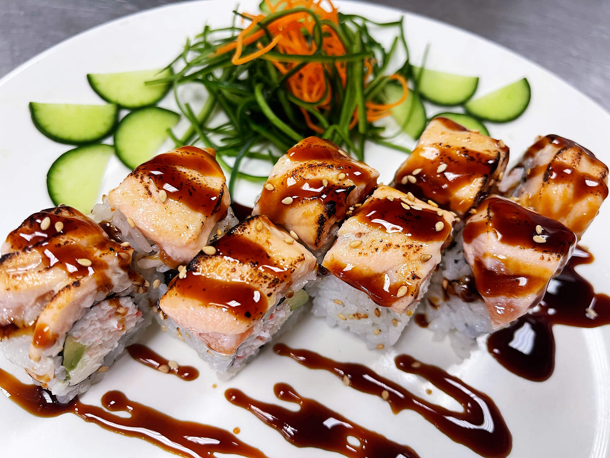 Sushi roll with seared salmon, drizzled with sauce at Aloha Hawaiian BBQ & Sushi, a Asian Fusion restaurant in Baldwin Park