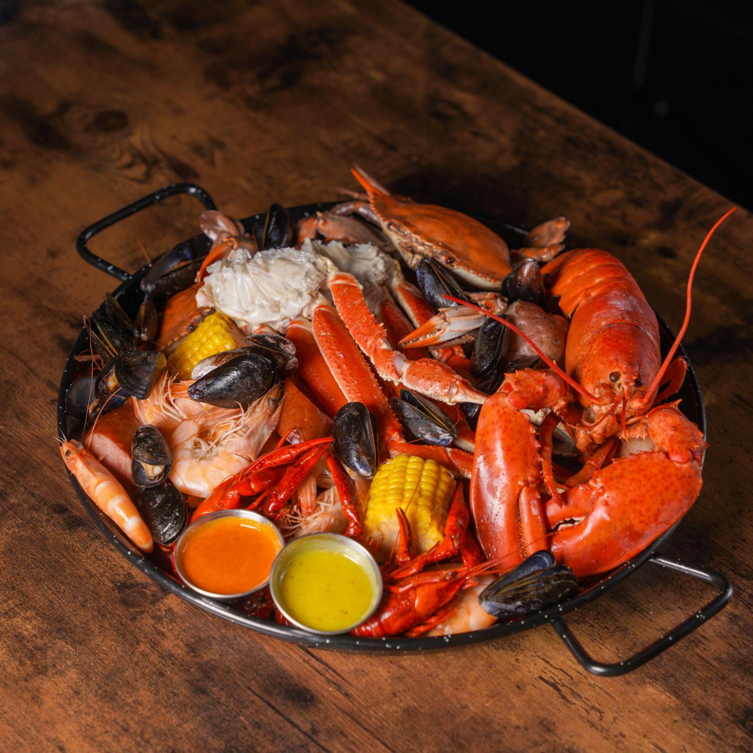 Aquabite-Cajun-Seafood-Restaurant-Lobster-Crab-And-Shrimp-Platter-Pasaden Platter with lobster, crab, shrimp and dipping sauces at Aquabite Cajun Seafood, a Seafood Restaurant in Pasaden