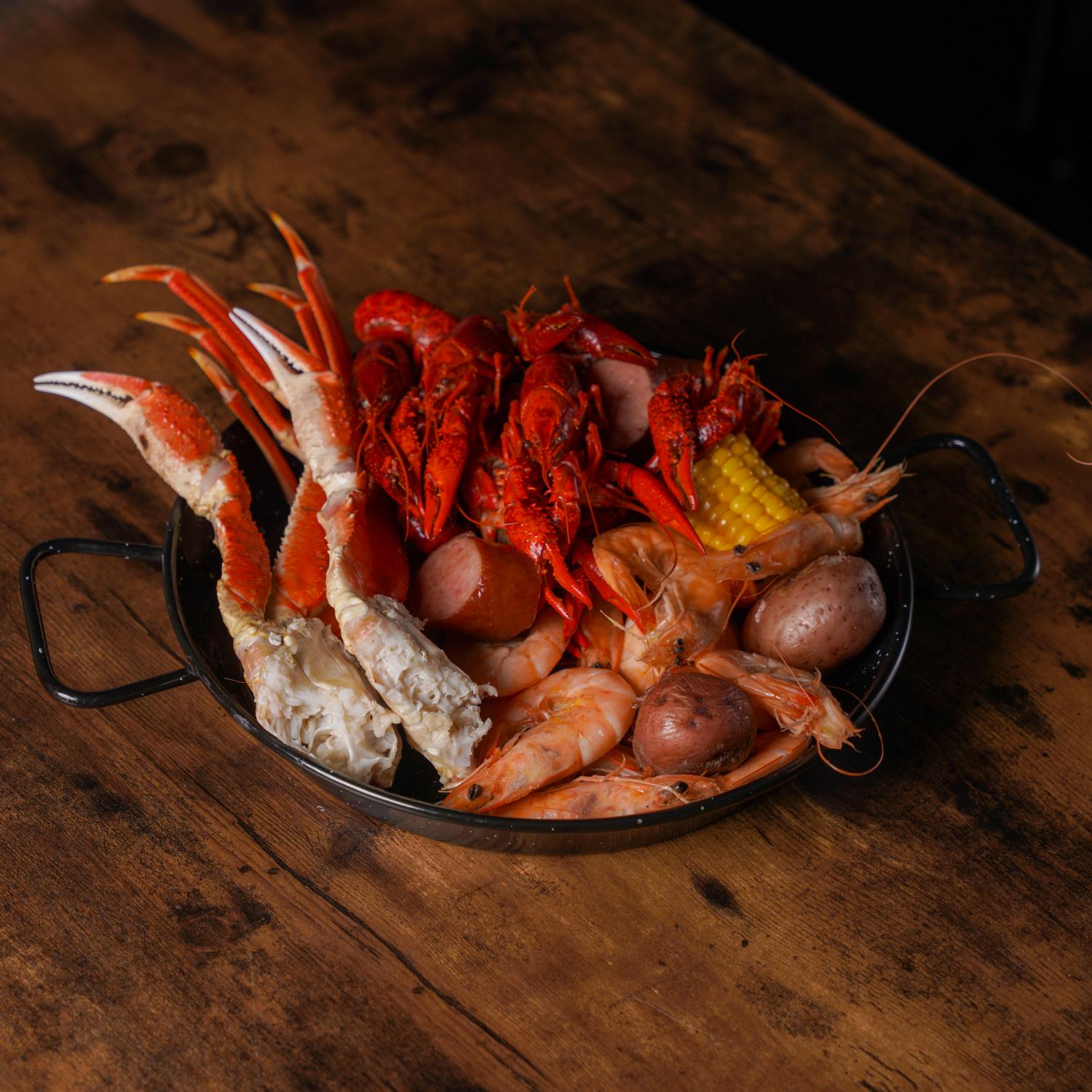 Aquabite-Cajun-Seafood-Restaurant-Crawfish-Shrimp-And-Crab-Legs-Platter-Pasaden Platter with crawfish, shrimp, crab legs and sausage at Aquabite Cajun Seafood, a Seafood Restaurant in Pasaden