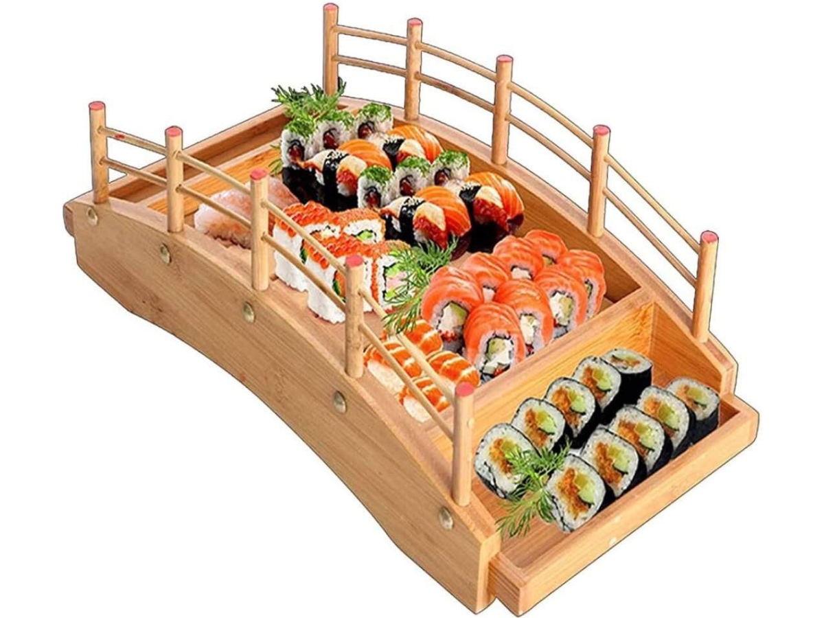 Sushi arranged on a wooden bridge - shaped platter.