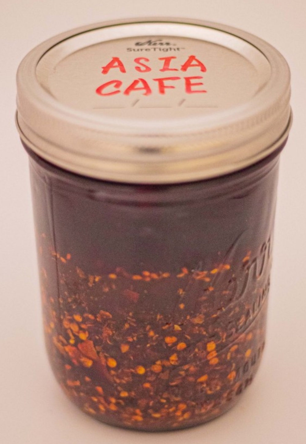 Homemade chili oil in a jar at Asia Cafe, a Chinese Restaurant in Austin