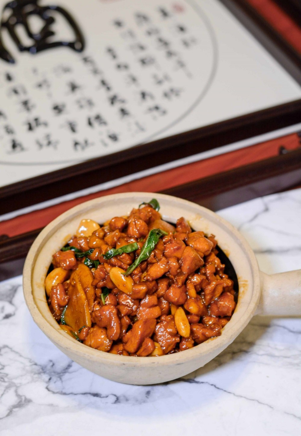 Kung Pao chicken in clay pot with peanuts at Asia Cafe, a Chinese Restaurant in Austin