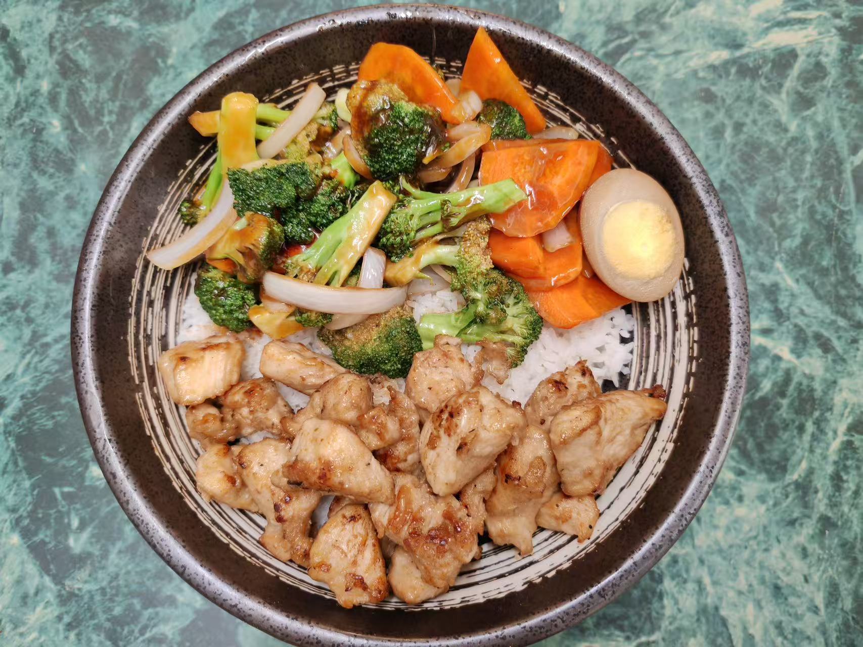 Grilled chicken rice bowl with veggies and a marinated boiled egg at Asia Hibachi & Rice Bowls，an Asian Fusion Restaurant in Buffalo