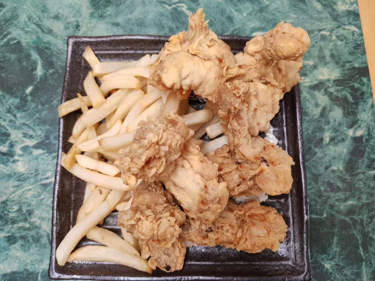 Crispy fried chicken pieces served with thick french fries at Asia Hibachi & Rice Bowls，an Asian Fusion Restaurant in Buffalo