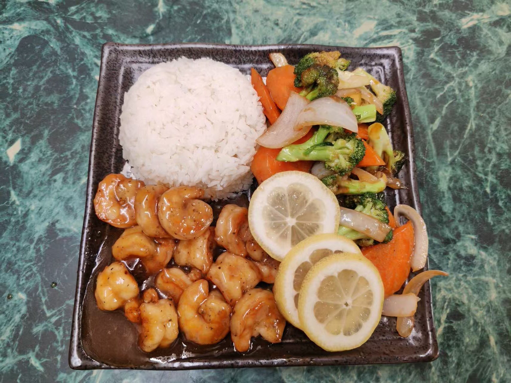 Glazed shrimp rice meal with mixed vegetables and lemon garnish at Asia Hibachi & Rice Bowls，an Asian Fusion Restaurant in Buffalo