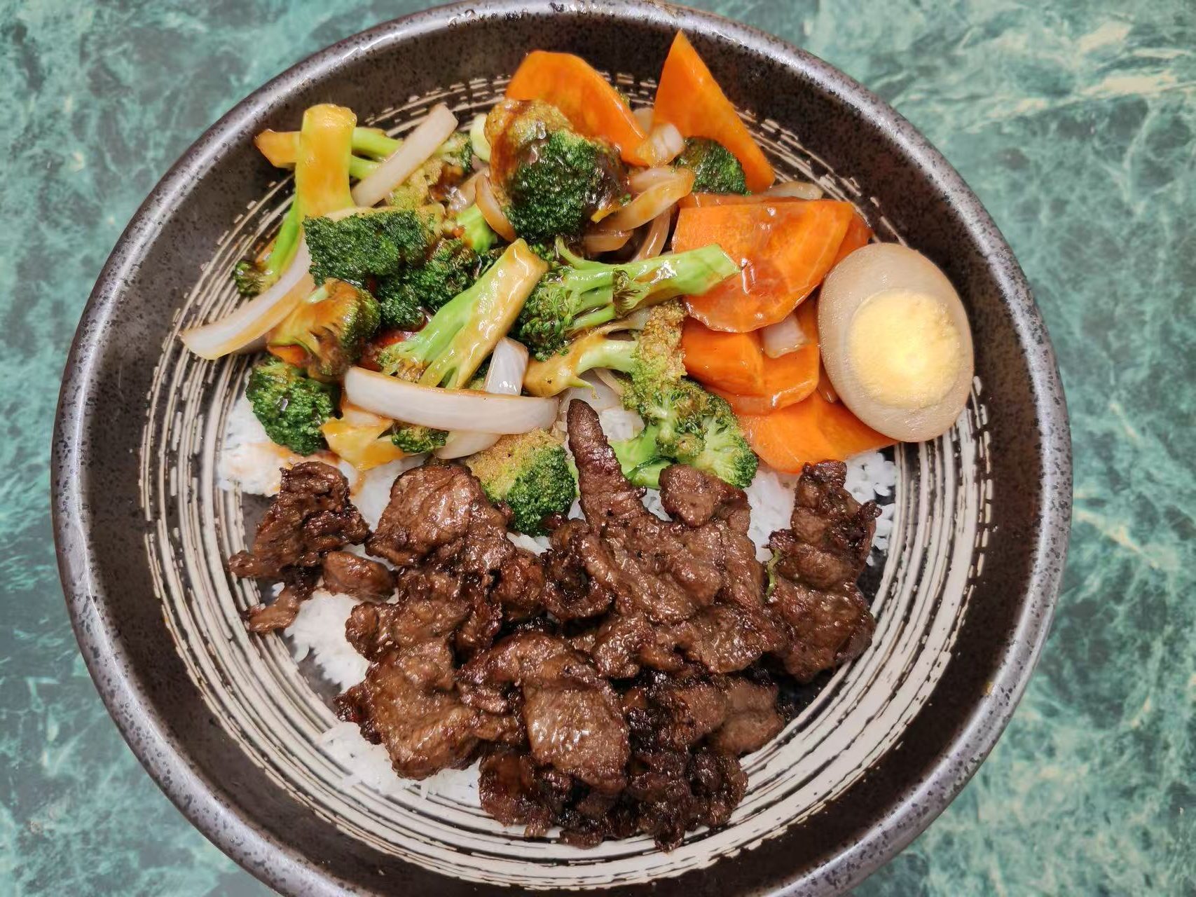 Beef rice bowl with vegetables and marinated boiled egg at Asia Hibachi & Rice Bowls，an Asian Fusion Restaurant in Buffalo